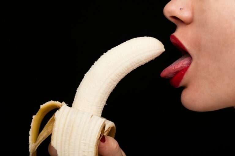 Women posing for blowjob to a banana for illustration